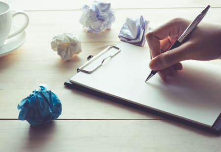 Human hand waiting for idea with notebook and crumpled paper.business inspiration concept.の写真素材