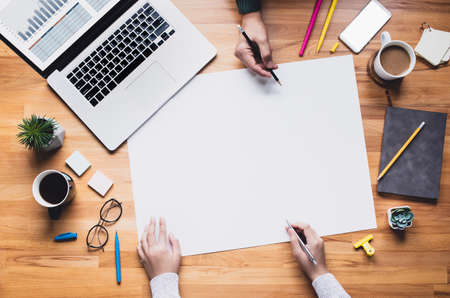 Top view of young person working on table with white space background.Business team.management of projectの写真素材