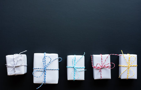 Simple gift box in diy style on dark background.giving and anniversary cocepts idea.top view