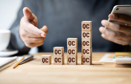 Quality of control concepts with QC sign on wood box.Business production and development