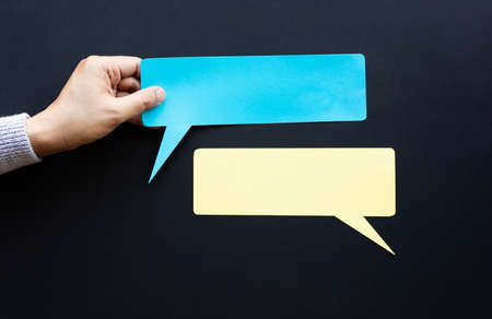 Conversation talk or word of mouth concepts with male hand holding blank paper.copy spaceの写真素材