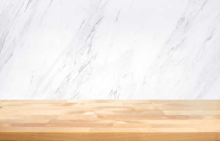 Empty wood table top with white marble  wall background.の写真素材