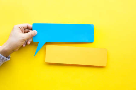 Person hand holding blank  bubbles speech paper in colorful background.for ecoration text.real photoの写真素材