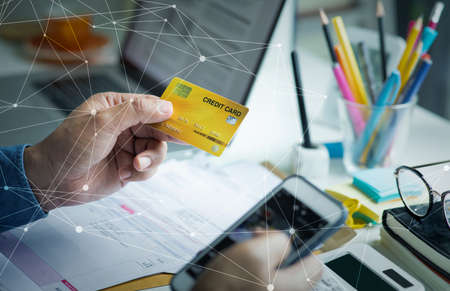 Person paymant bill with credit card on desk table.business financial and cost concepts.data...
