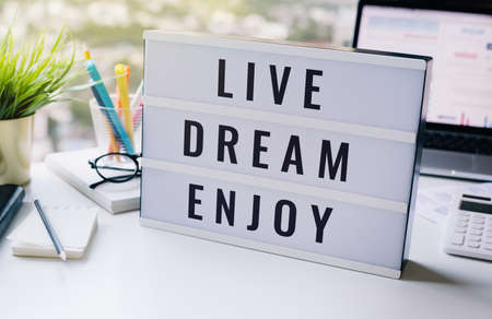 Live,dream,enjoy,ext on lightbox business motivation concepts.happy with workの写真素材