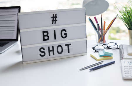 Big hot text with lightbox on desk table.business investment