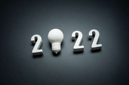 2022 Creativity and inspiration ideas concepts with lightbulb on dark color background.Business...