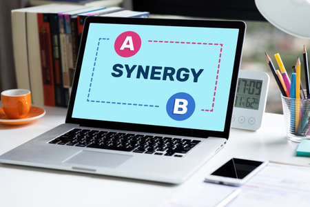 Synergy and connection of business with text on laptop.partnerships or cooperation to success.no peopleの写真素材