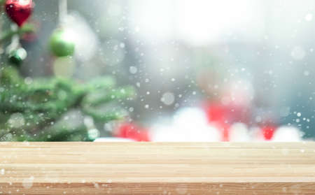 Selective focus.Empty wood table top with blur abstract light bokeh of christmas tree,decoration...