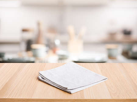 Fabric,cloth on wood table top on blur kitchen counter (room)background.For montage product display...