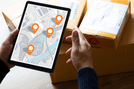 Delivery and online shopping concepts with young person using digital map with tablete on product...