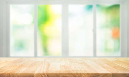 Empty wood table top on blur abstract green garden from window view. For montage product display or design key visual layoutの写真素材
