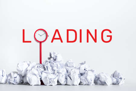 Loading ideas and timing concepts with paper crumpled ball and red clock.business performanceの写真素材