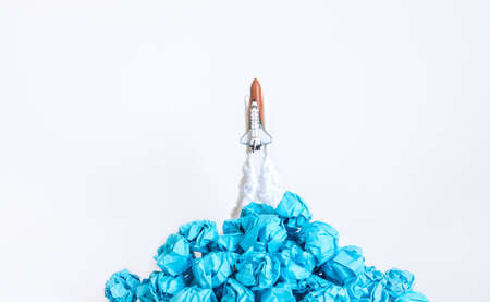 Ideas inspiration concepts with rocket and paper crumpled ball on white background.creativity of humanの写真素材