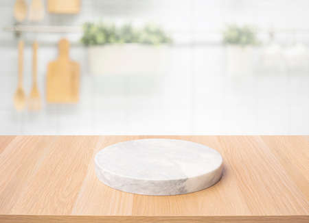 Selective focus.Wood table top with chopping board with blur kitchen counter background.For montage...