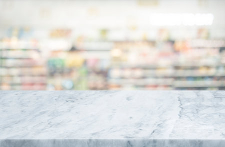 Selective focus.Marble table top on blur of supermarket product shelf background.business and shopping concepts ideasの写真素材