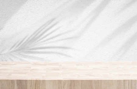 Selective focus.Wood table or  product display platform design with shadow palm leaf on wall background.luxury minimal presentationの写真素材