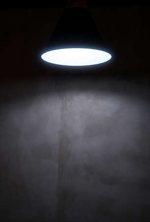 The lamp illuminated the black wall