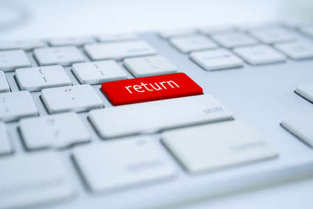 white computer keyboard and red return buttonの写真素材