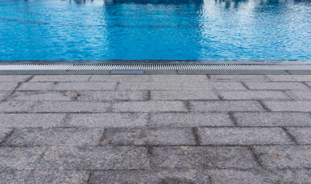 poolside and the blue swimming pool waterの写真素材