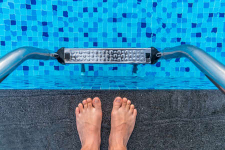 feet on the edge of the swimming poolの写真素材