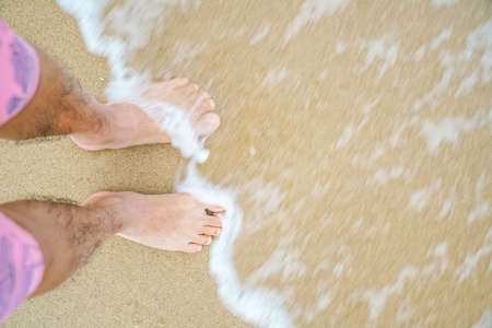 barefoot on the yellow clean beachの写真素材