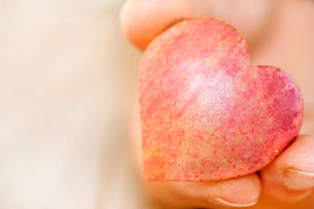 hand holding apple pie with heart shape, concept of loveの写真素材