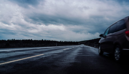 car driving in the road, dark background.