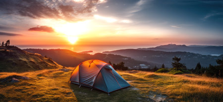 Camping tent on the top of the mountain in the rays of the rising sun.の素材