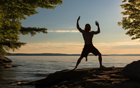 yoga enthusiast practicing poses on the beach in sunsetの素材