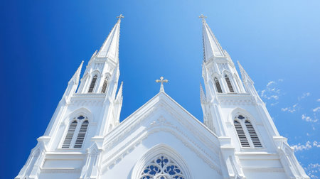 A beautifully designed white church with two majestic towers against a clear, vibrant blue sky, symbolizing faith and community.の素材