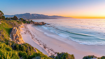 A tranquil beach scene at dawn showcasing gentle waves crashing against a rocky coastline. The warm light of sunrise creates a stunning palette, inviting relaxation and contemplation.の素材