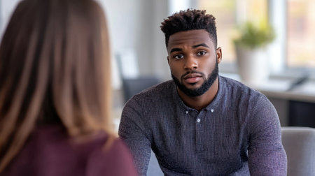 Emotional therapy session with a student and counselor in a serene, supportive environment, highlighting mental health careの素材