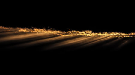 Radiant golden sun rays glowing against a pitch-black background, creating a dramatic contrast of light and shadowの素材
