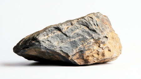 A single rock with rugged texture, isolated on a white background, perfect for nature or minimalist designsの素材