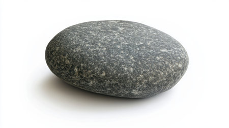 A smooth, round gray pebblestone isolated on a white background, highlighting its simplicity and natural beauty.の素材