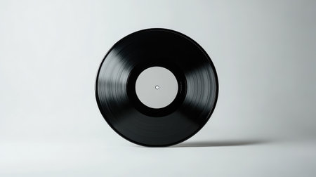 Mockup of a black vinyl record on a white background, a blank canvas for music design presentations.の素材