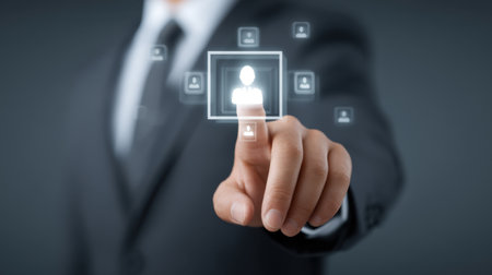 A businessman uses his finger to interact with a digital user interface, emphasizing the importance of virtual connections and modern technology in networking and communication.の素材