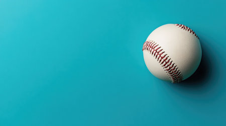 A baseball resting on a clean, uncluttered background with space for copy, creating a simple sports banner.の素材