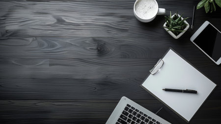 Top view of a clean office desk with a blank notepadの素材
