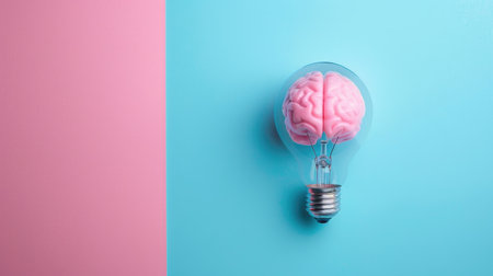 Brain inside a transparent light bulb on blue and pink pastel background, symbolizing brainstorming and creative ideas. Concept of knowledge with copy spaceの素材