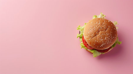 Cheeseburger on a pink background, with extensive empty space around for adding promotional text or visuals.の素材