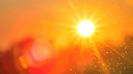 Scenic view of a bright orange sun with lens flare against a clear sky, ideal for conveying the essence of hot summer days.の素材