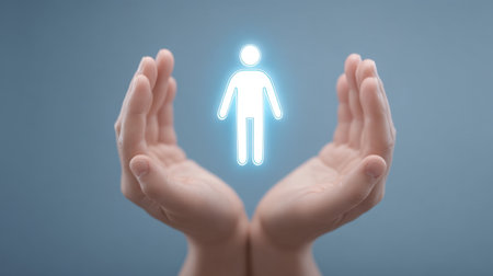Hands gently support a glowing healthcare icon, symbolizing care and compassion. This image represents wellness, safety, and the importance of human connection in healthcare.の素材