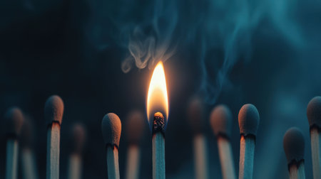 A single burning match standing out from unlit ones, representing leadership and innovation in a striking compositionの素材