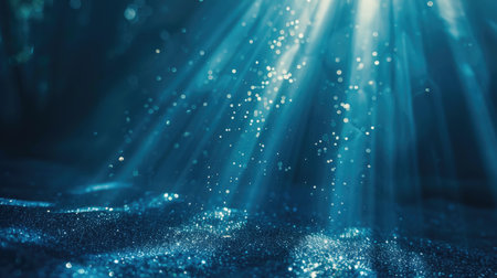 Blue glitter particles in an endless fall, illuminated by soft and delicate light rays, creating an enchanting loopの素材