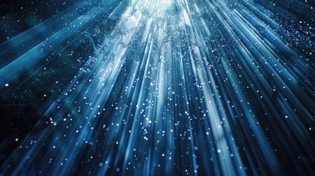 Enchanting and continuous loop of blue glitter particles softly descending in delicate light raysの素材