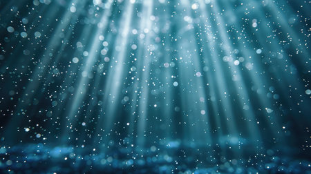 Soft light rays illuminating falling blue glitter particles, creating an enchanting and continuous loop effectの素材