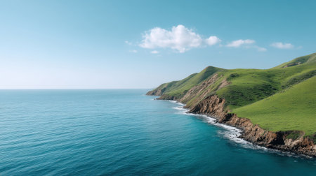 A breathtaking view of verdant hills descending into a serene sea, featuring vibrant blues and soft clouds, perfect for showcasing nature's beauty and tranquil escapes.の素材