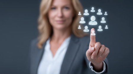 A professional manager evaluates a talent pool for team excellence using a digital interface in a modern business environment, highlighting leadership and strategy.の素材